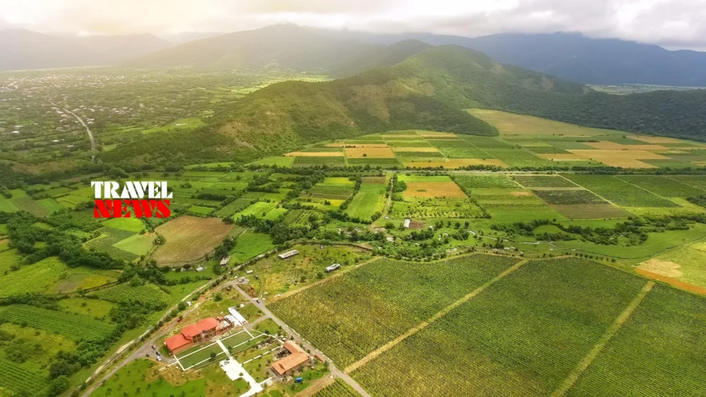 Green rural landscape, agricultural fields and mountains in Georgia, illustrating the potential of regenerative tourism კოპირება